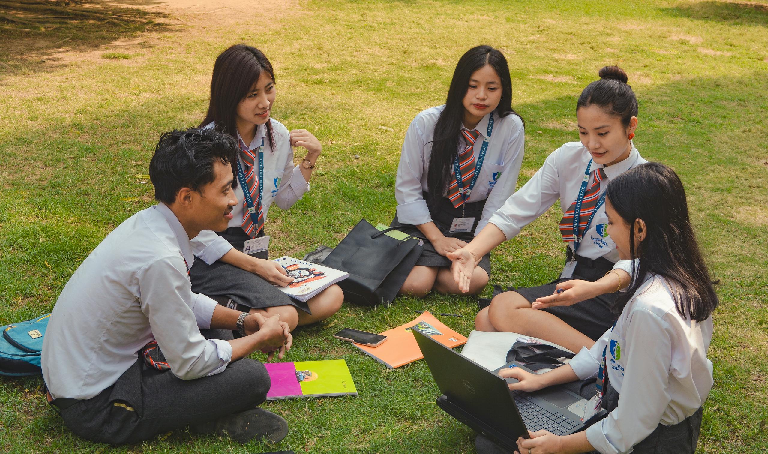 A group of college students studying together on a sunny day in Dimapur, India. Students in Thane