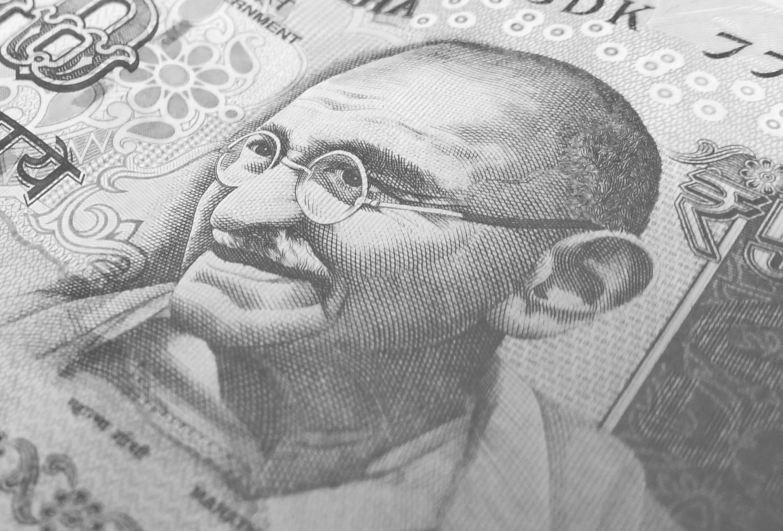 Detailed monochrome depiction of an Indian rupee banknote with Gandhi's portrait, symbolizing finance and economy. Wealth Management